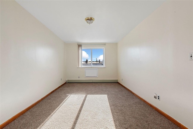 carpeted empty room featuring a baseboard radiator