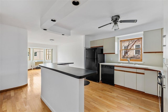 kitchen featuring black appliances, white cabinets, sink, ceiling fan, and light hardwood / wood-style floors