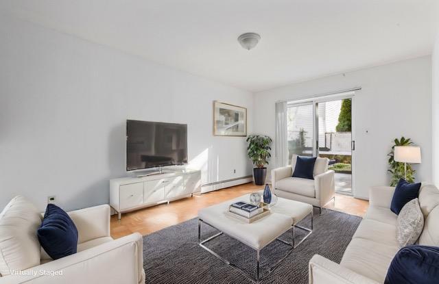 living room with a baseboard heating unit