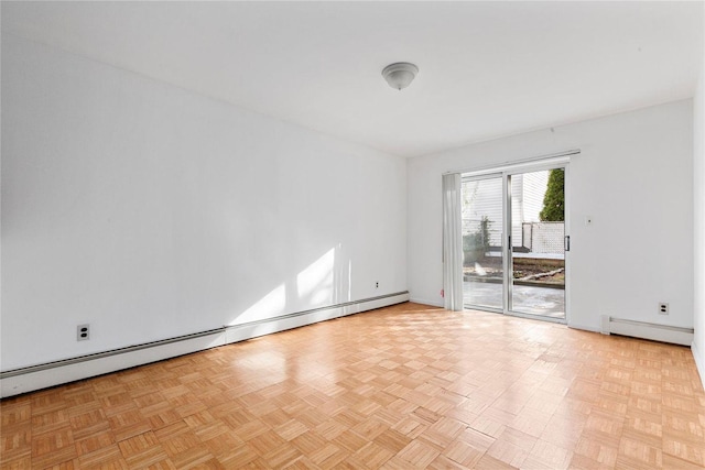 spare room featuring light parquet floors and a baseboard heating unit