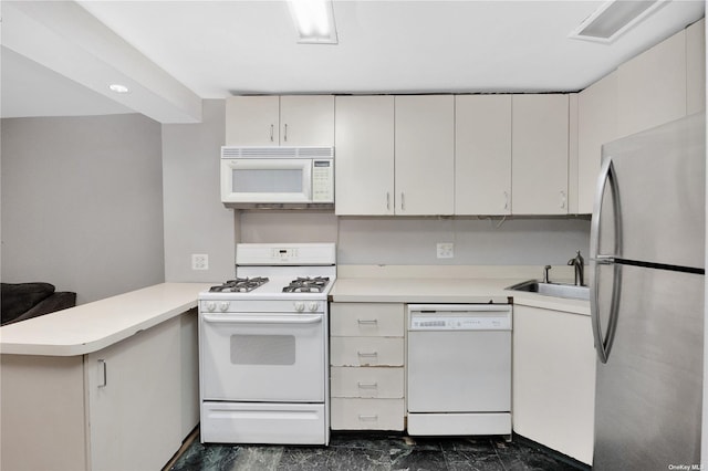 kitchen with kitchen peninsula, white appliances, white cabinetry, and sink