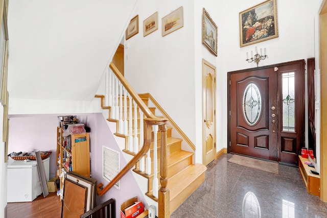 foyer featuring a towering ceiling