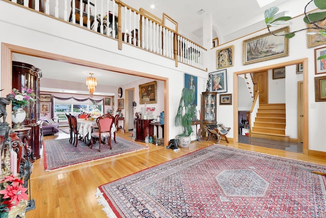 entrance foyer with a chandelier, a high ceiling, and hardwood / wood-style flooring