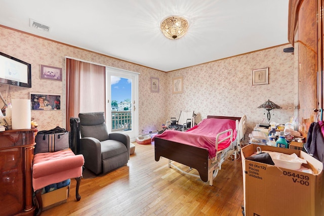 bedroom featuring wood-type flooring and crown molding