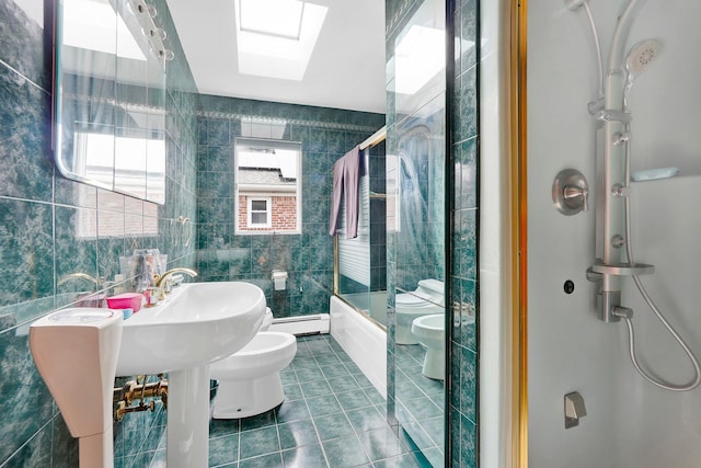 bathroom with a skylight, baseboard heating, a bidet, tile walls, and toilet