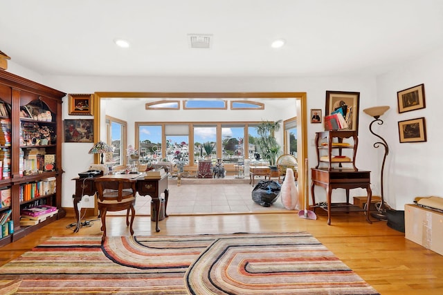 sitting room with wood-type flooring