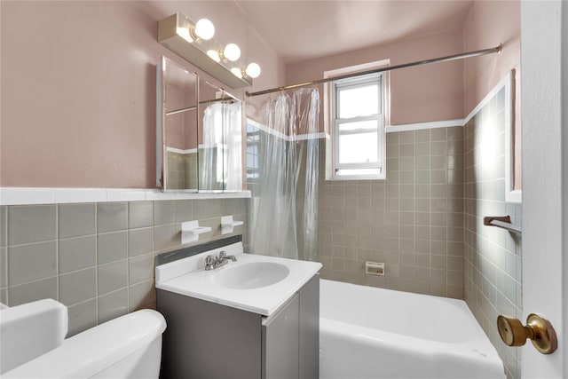 full bathroom featuring toilet, tile walls, vanity, and shower / tub combo with curtain