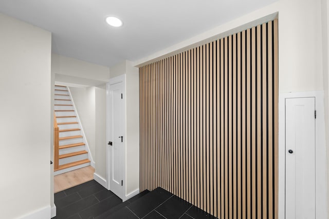 corridor featuring dark tile patterned flooring