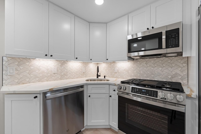 kitchen with white cabinetry, sink, and appliances with stainless steel finishes