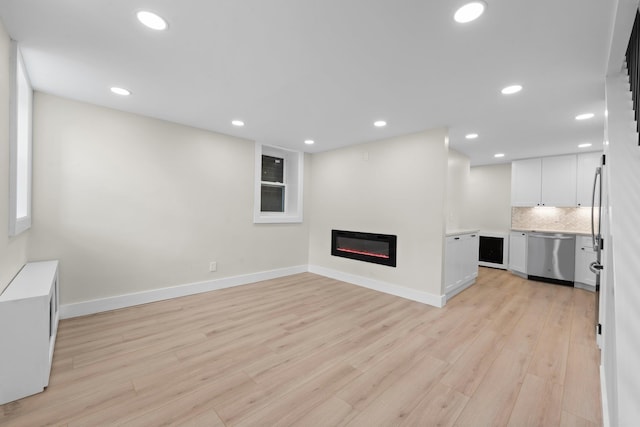 unfurnished living room with light hardwood / wood-style flooring