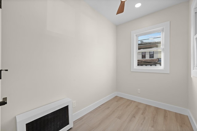 interior space featuring heating unit, light hardwood / wood-style flooring, and ceiling fan