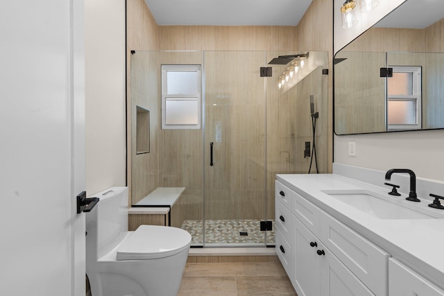 bathroom with vanity, a shower with shower door, and toilet