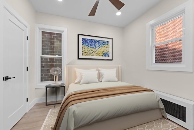 bedroom with ceiling fan and light hardwood / wood-style floors