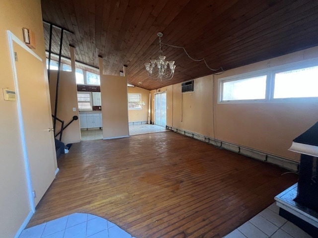 empty room with wooden ceiling, vaulted ceiling, a notable chandelier, light hardwood / wood-style floors, and a wall unit AC