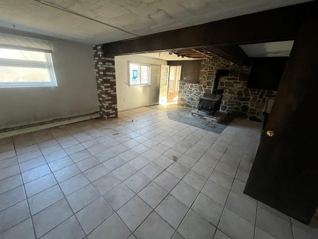 unfurnished living room with a wood stove