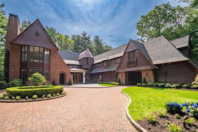 view of front of house featuring a front lawn and a sunroom