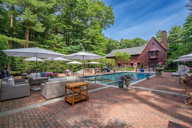 view of pool with outdoor lounge area and a patio