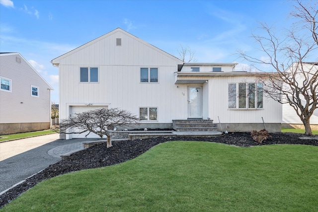 view of front of house featuring a front yard and a garage