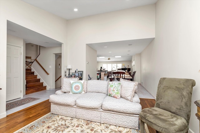 living room with ceiling fan and light wood-type flooring