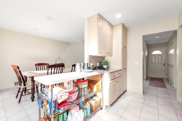 kitchen with cream cabinets and light tile patterned floors