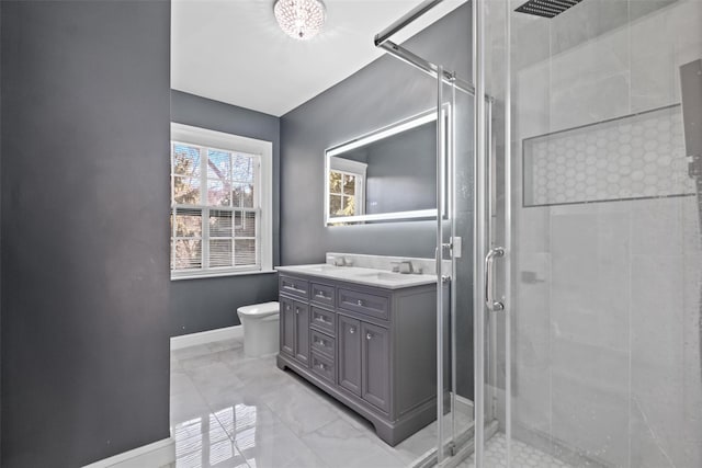 full bath featuring marble finish floor, toilet, a shower stall, vanity, and baseboards