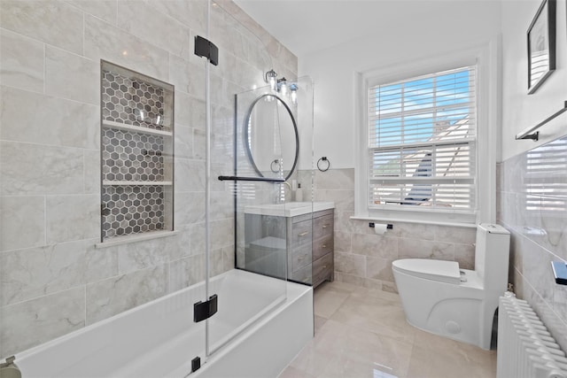 full bathroom featuring radiator, a shower with shower door, tile walls, and toilet