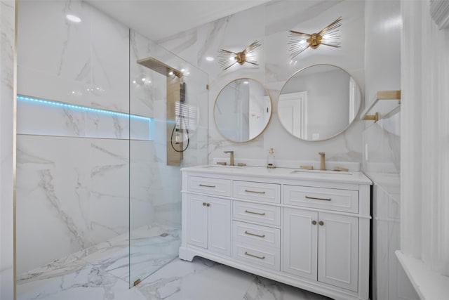 full bath with double vanity, marble finish floor, a marble finish shower, and a sink