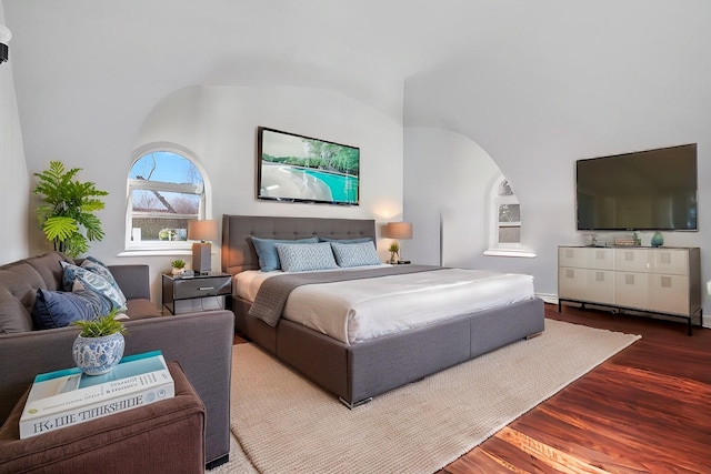 bedroom featuring lofted ceiling and wood finished floors