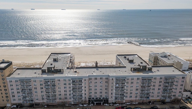 aerial view featuring a view of the beach and a water view