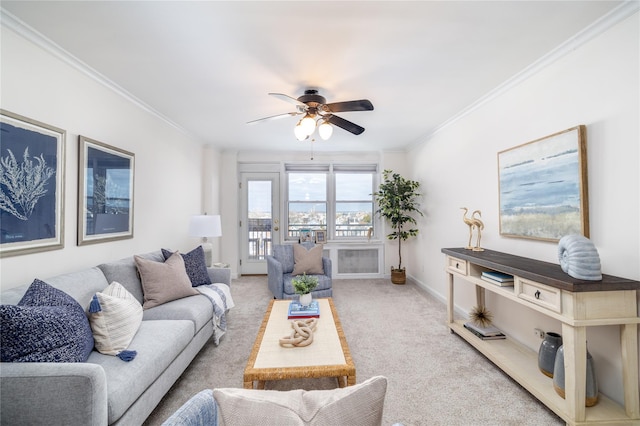 carpeted living room with crown molding and ceiling fan