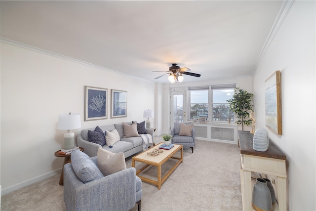 living room featuring light colored carpet, ceiling fan, and ornamental molding