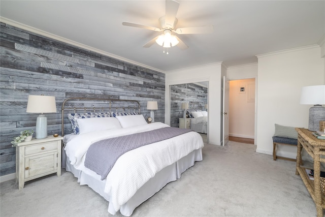 bedroom featuring ceiling fan, wood walls, crown molding, and light carpet