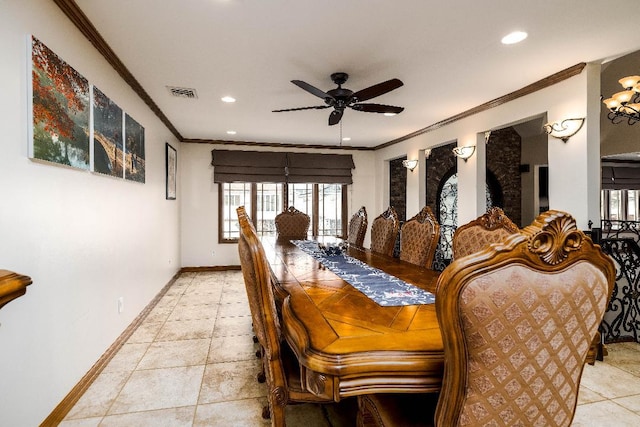 tiled dining room with ceiling fan and ornamental molding