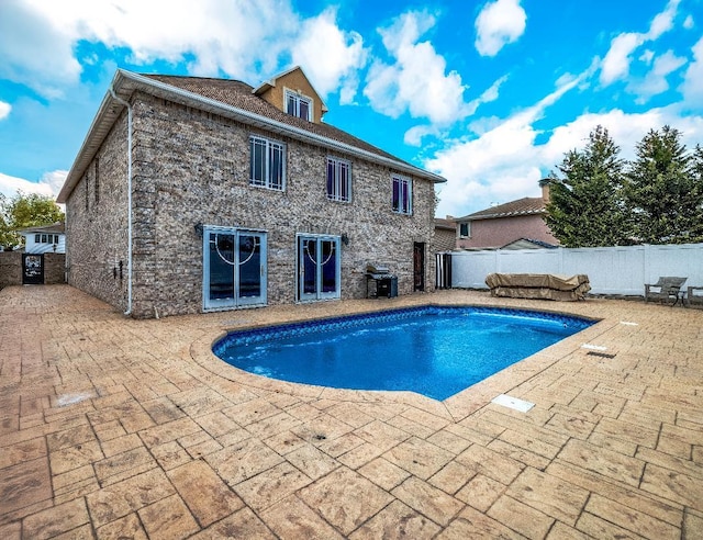 view of pool with a patio, a fenced backyard, a fenced in pool, and a grill