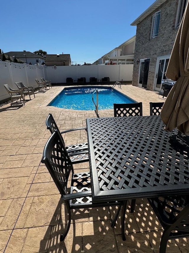 view of pool featuring a patio area, fence, and a fenced in pool