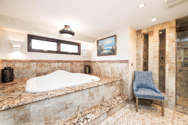 full bath featuring visible vents, tile walls, and tile patterned floors