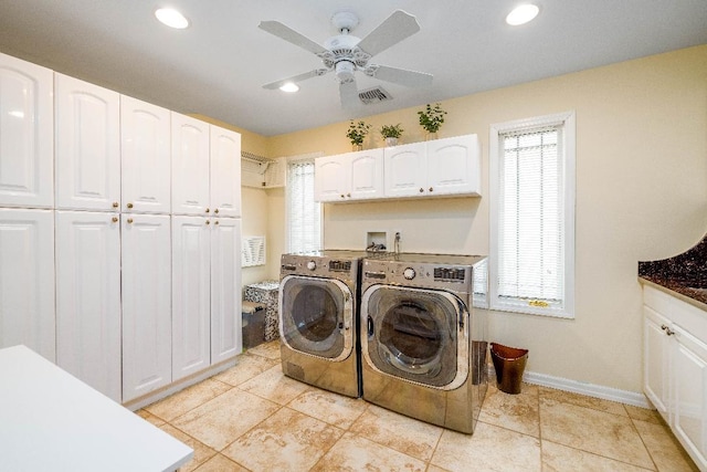 clothes washing area with separate washer and dryer, visible vents, baseboards, a ceiling fan, and cabinet space