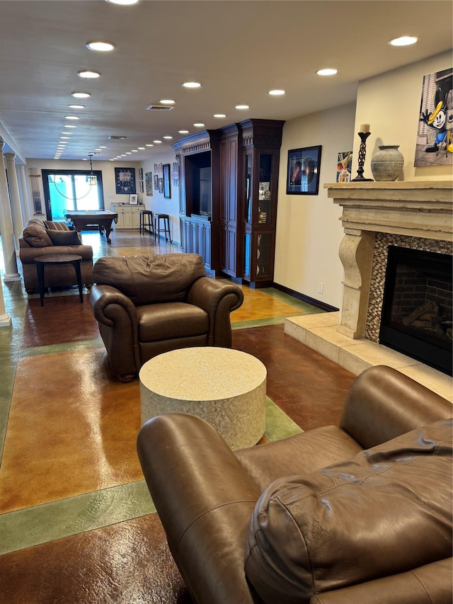 living room with recessed lighting, pool table, a high end fireplace, concrete floors, and baseboards