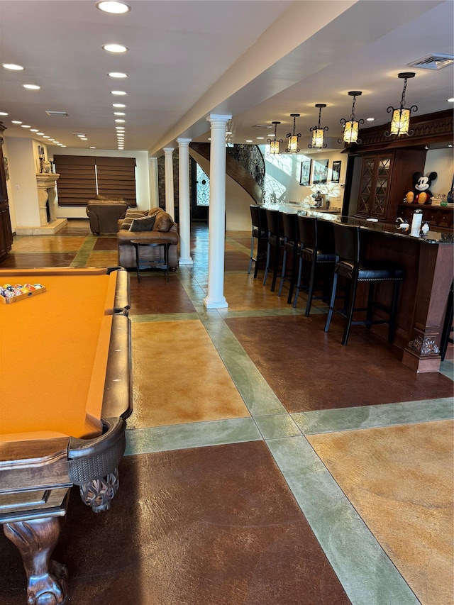 bar with pendant lighting, recessed lighting, a community bar, and ornate columns