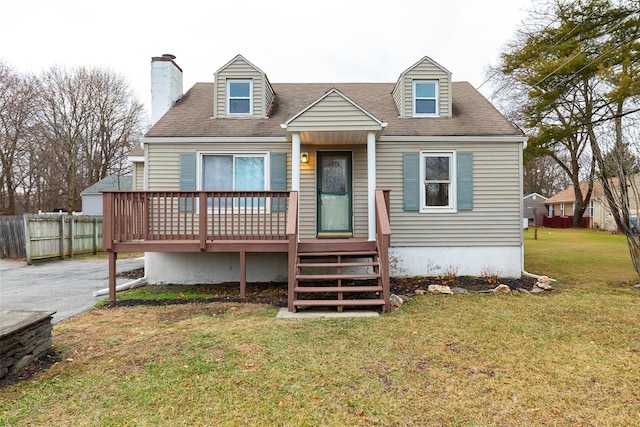 back of property with a yard and a wooden deck