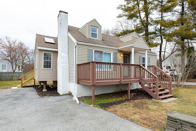 back of house featuring a wooden deck