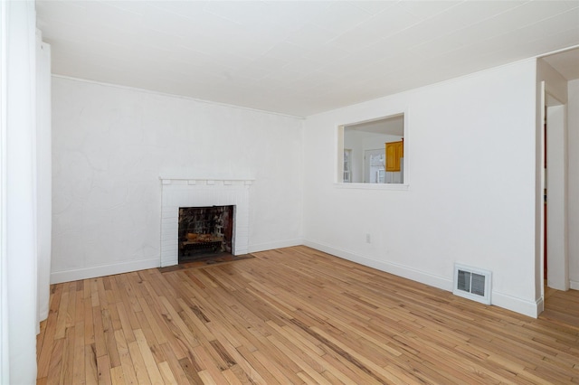 unfurnished living room with light wood-type flooring and a fireplace