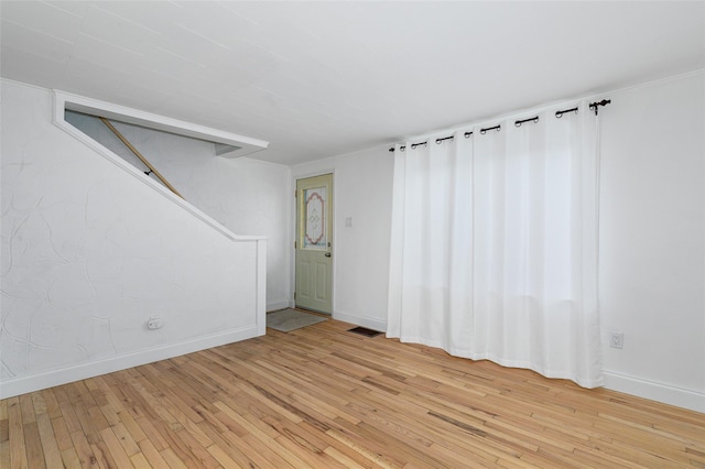 unfurnished room with light wood-type flooring