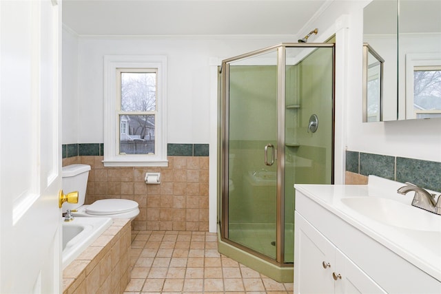 full bathroom featuring plus walk in shower, vanity, tile patterned flooring, and crown molding