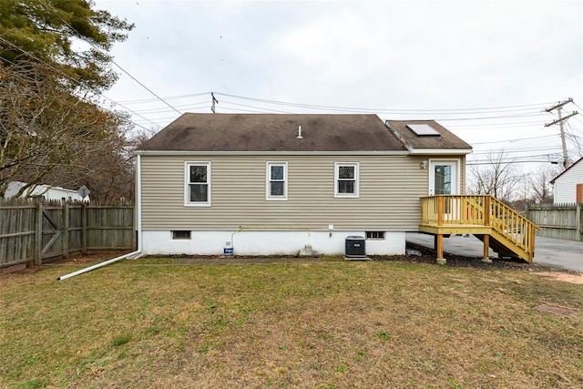 back of property featuring a yard and central AC unit