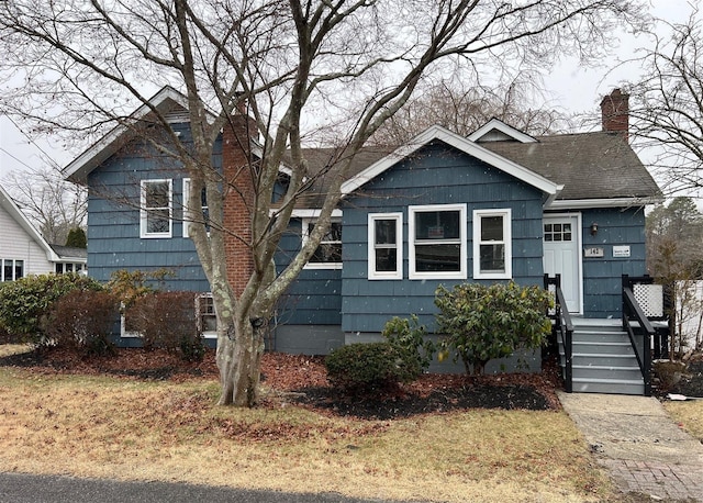 bungalow-style home with a chimney