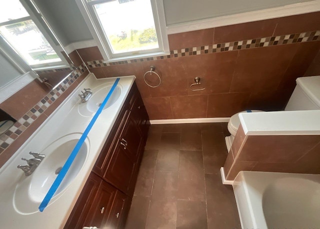 full bath with vanity, tile walls, toilet, and tile patterned floors