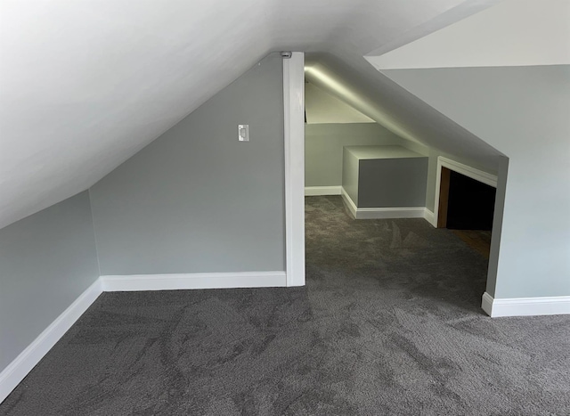 additional living space with carpet floors, vaulted ceiling, and baseboards