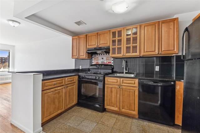 kitchen with decorative backsplash, sink, kitchen peninsula, and black appliances