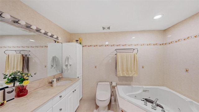 bathroom featuring vanity, a relaxing tiled tub, tile patterned floors, and toilet